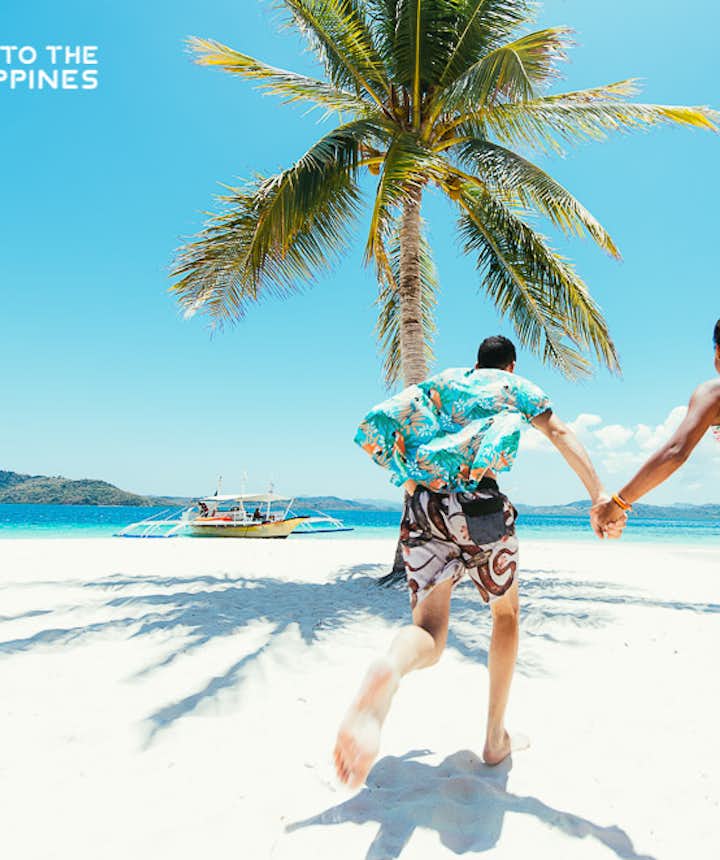 Couple at a white sand beach in Coron, Palawan, Philippines