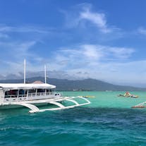 View of a boat and people at Tañon Strait