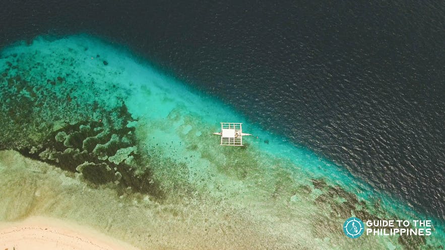 Aerial view of a boat in Pamilacan Island, Bohol