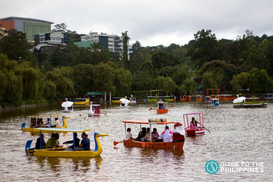 Travelers enjoy boating at Burnham Park in Baguio City, Philippines