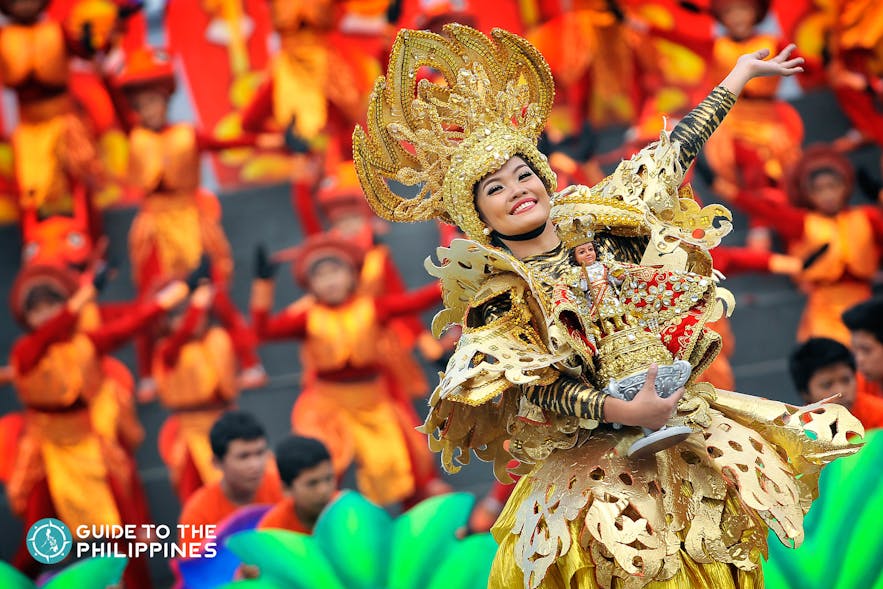 Lady carrying an image of the Santo Niño at the annual street parade of Sinulog Festival in Cebu, Philippines