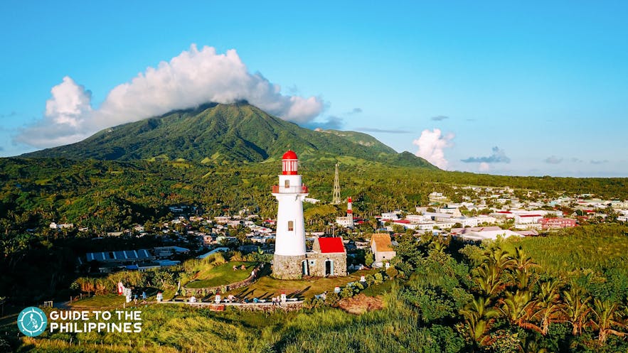 Sunset view of Mt. Iraya featuring the Basco Lighthouse of Batanes