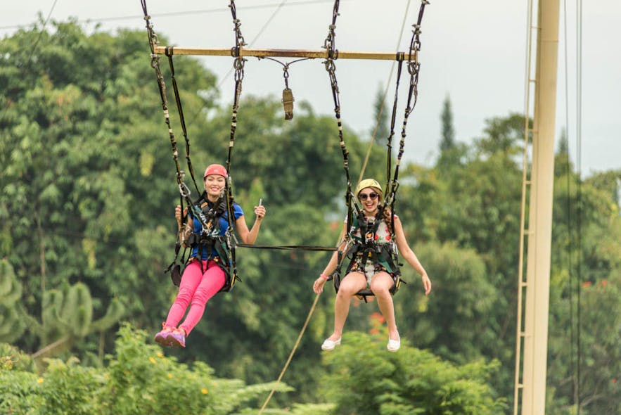 Travelers doing the Skyswing activity at Eden Nature Park Resort in Davao