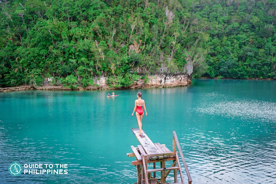 Girl about to jump off into the Sugba Lagoon of Siargao