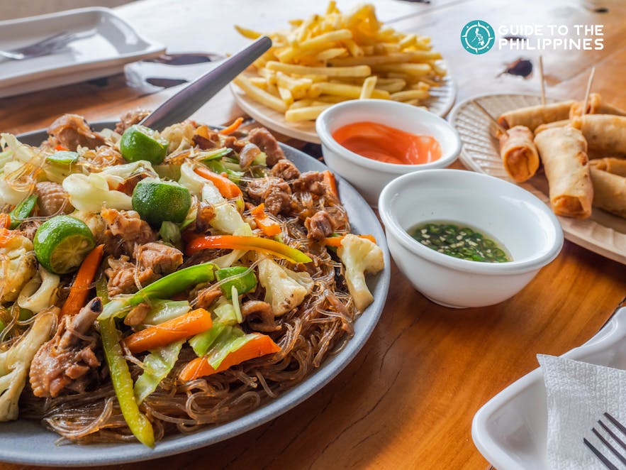 Pancit Sotanghon, tuna spring rolls, and French fries in the Philippines