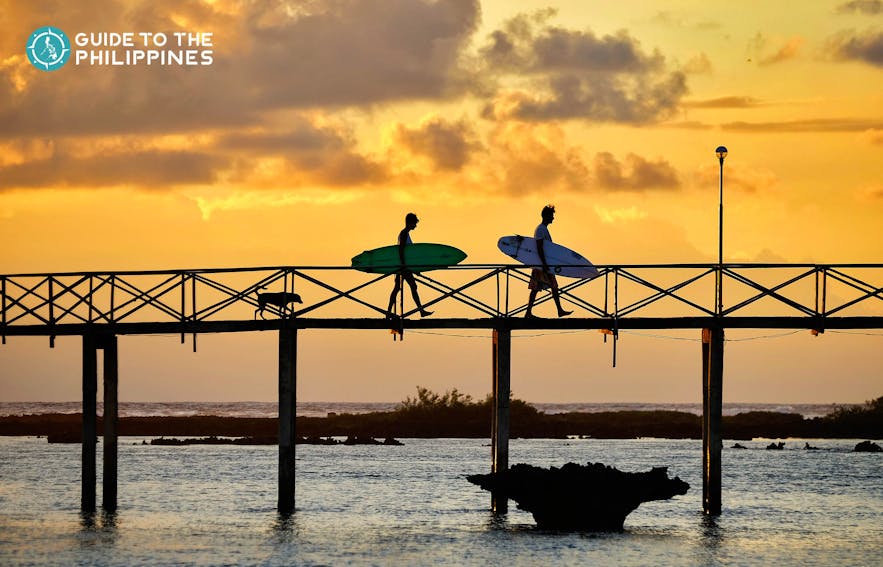 Surfers and sunset at Cloud 9 in Siargao Island