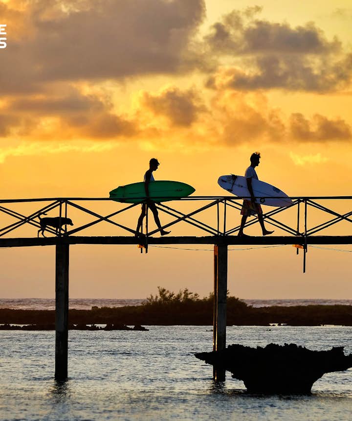 Surfers and sunset at Cloud 9 in Siargao Island
