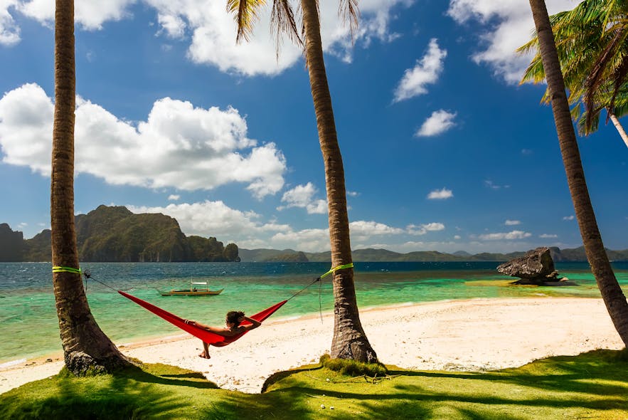 Lady in a hammock at a beach in El Nido, Palawan