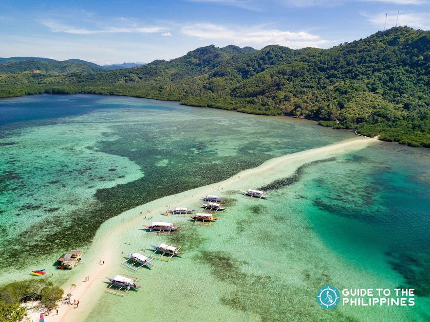 Aerial drone shot of boats at Snake Island in El Nido, Palawan