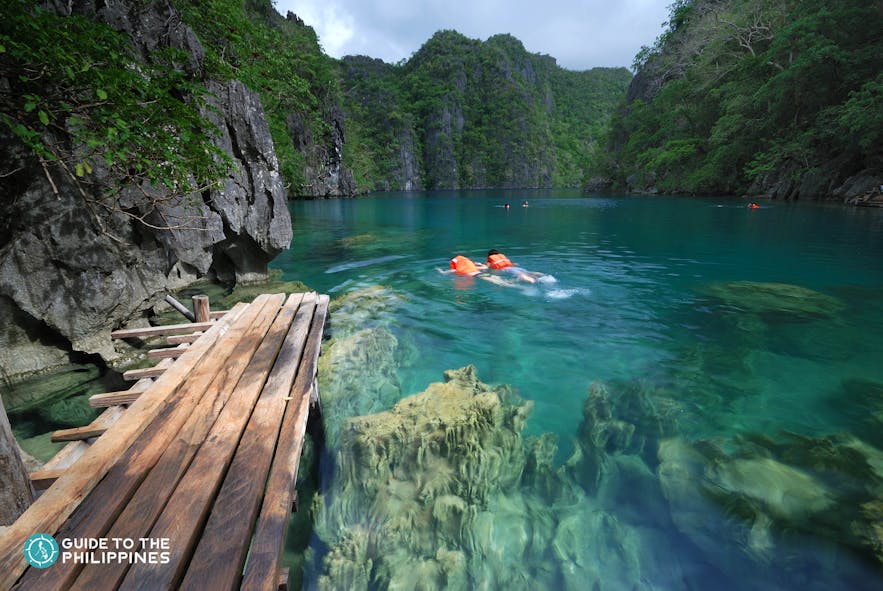Travelers swimming at Kayangan Lake in Coron, Palawan