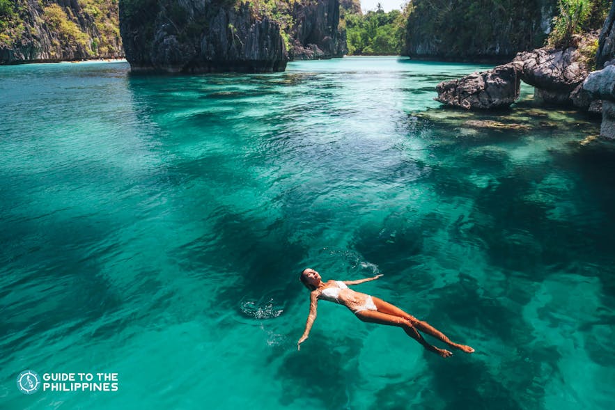 Traveler floating along a lagoon in El Nido, Palawan