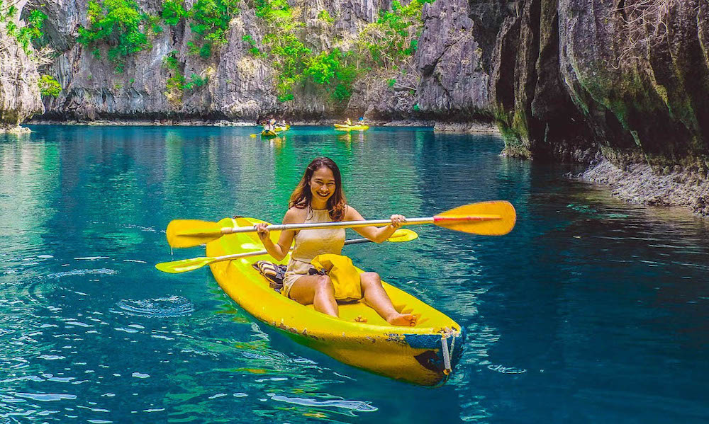 A girl kayaking in Big Lagoon Palawan