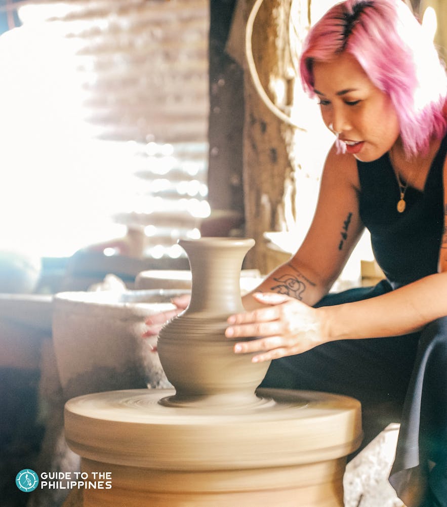 Traveler getting a hand at pottery making in RG Jar, Ilocos Sur