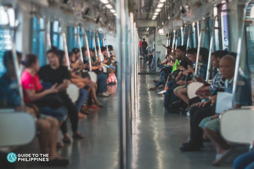 People riding the LRT in Manila