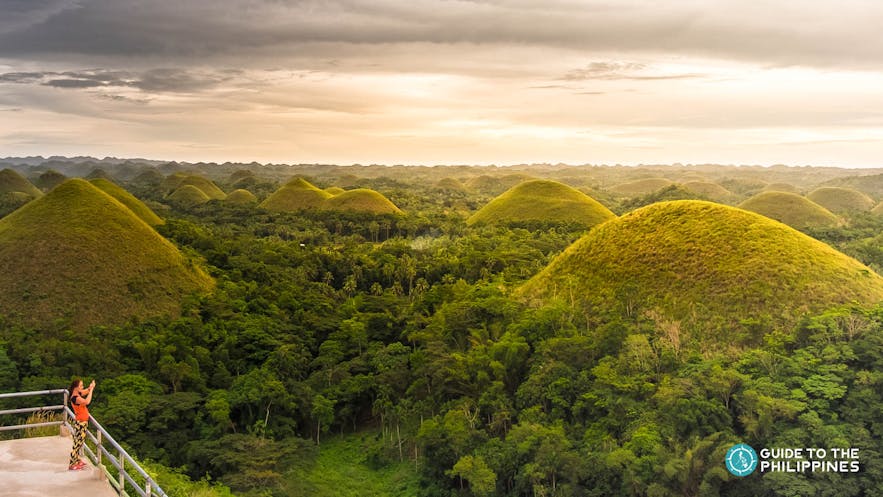 Traveler taking a photo from the Chocolate Hills Complex Viewpoint in Carmen, Bohol