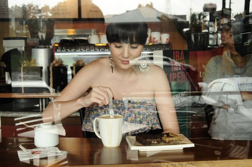 A woman drinking coffee in Cafe de Lipa
