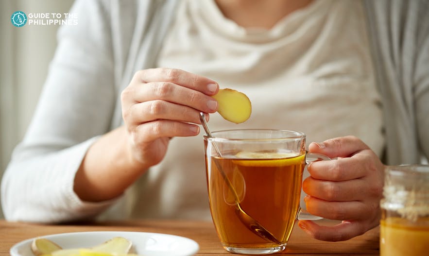 Woman drinking a cup of ginger tea