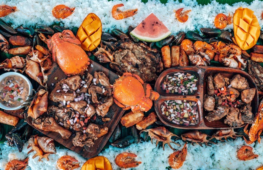 A boodle fight made from grilled meat and fresh seafood in the Philippines
