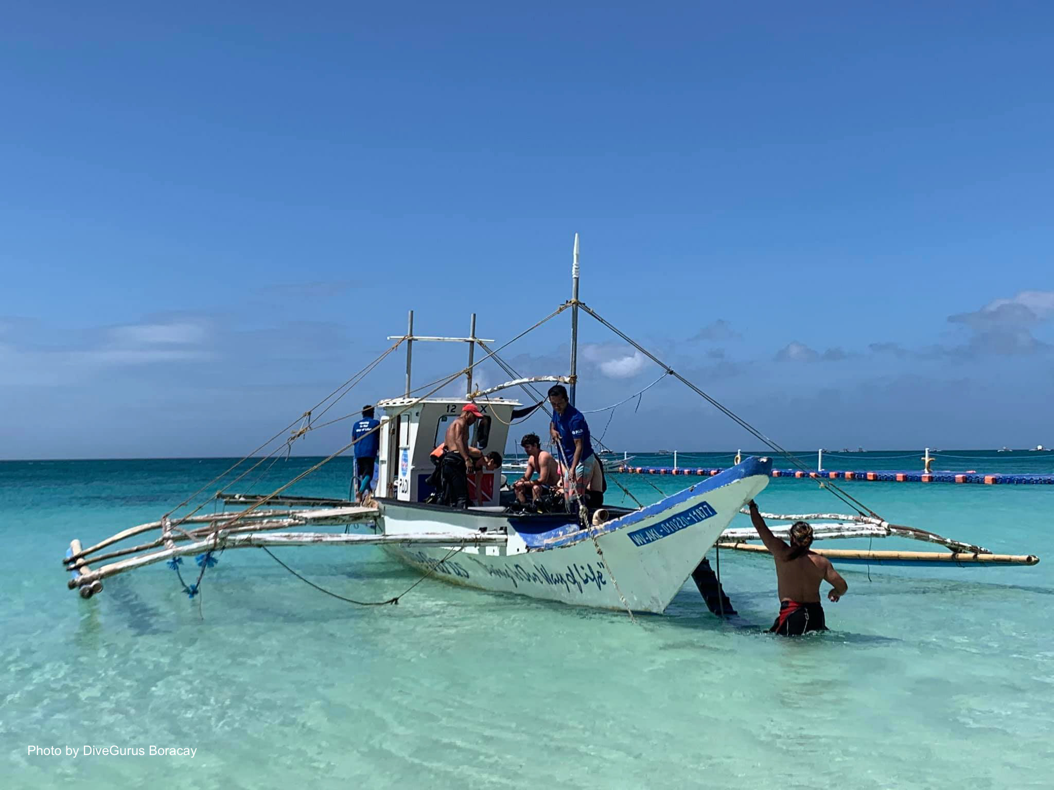 Divers riding a boat going to a dive spot in Boracay