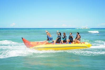 Five travellers enjoying the banana boat ride offered by Bohol Beach Club