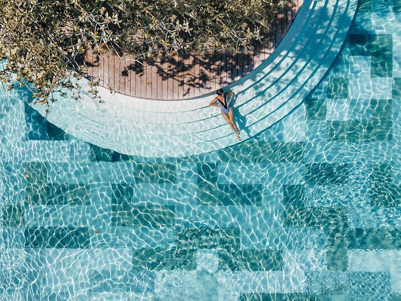 Woman enjoying the sun in one of Amorita Resort 's pool