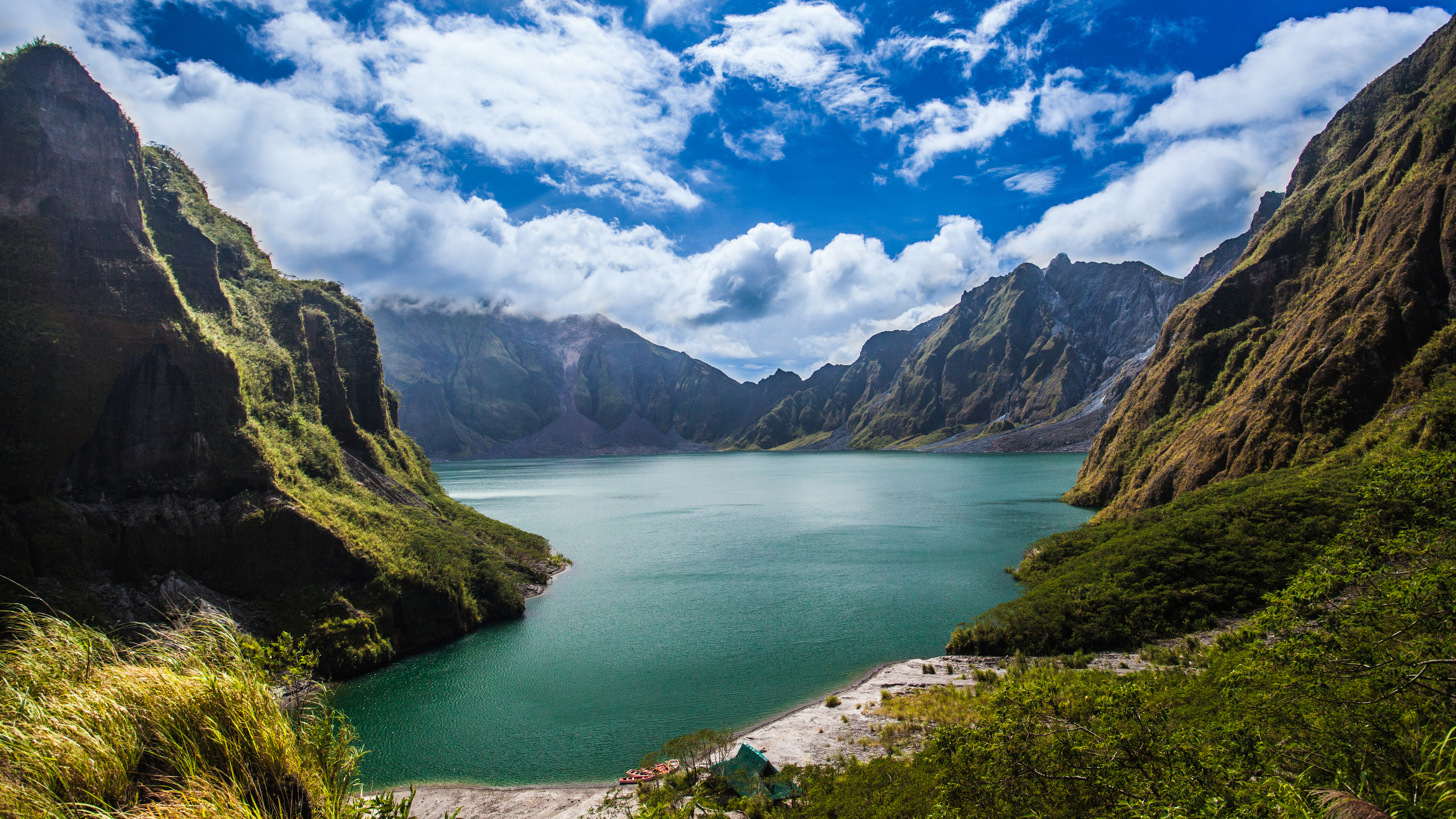 Blue waters and green landscape in Mount Pinatubo Crater Lake