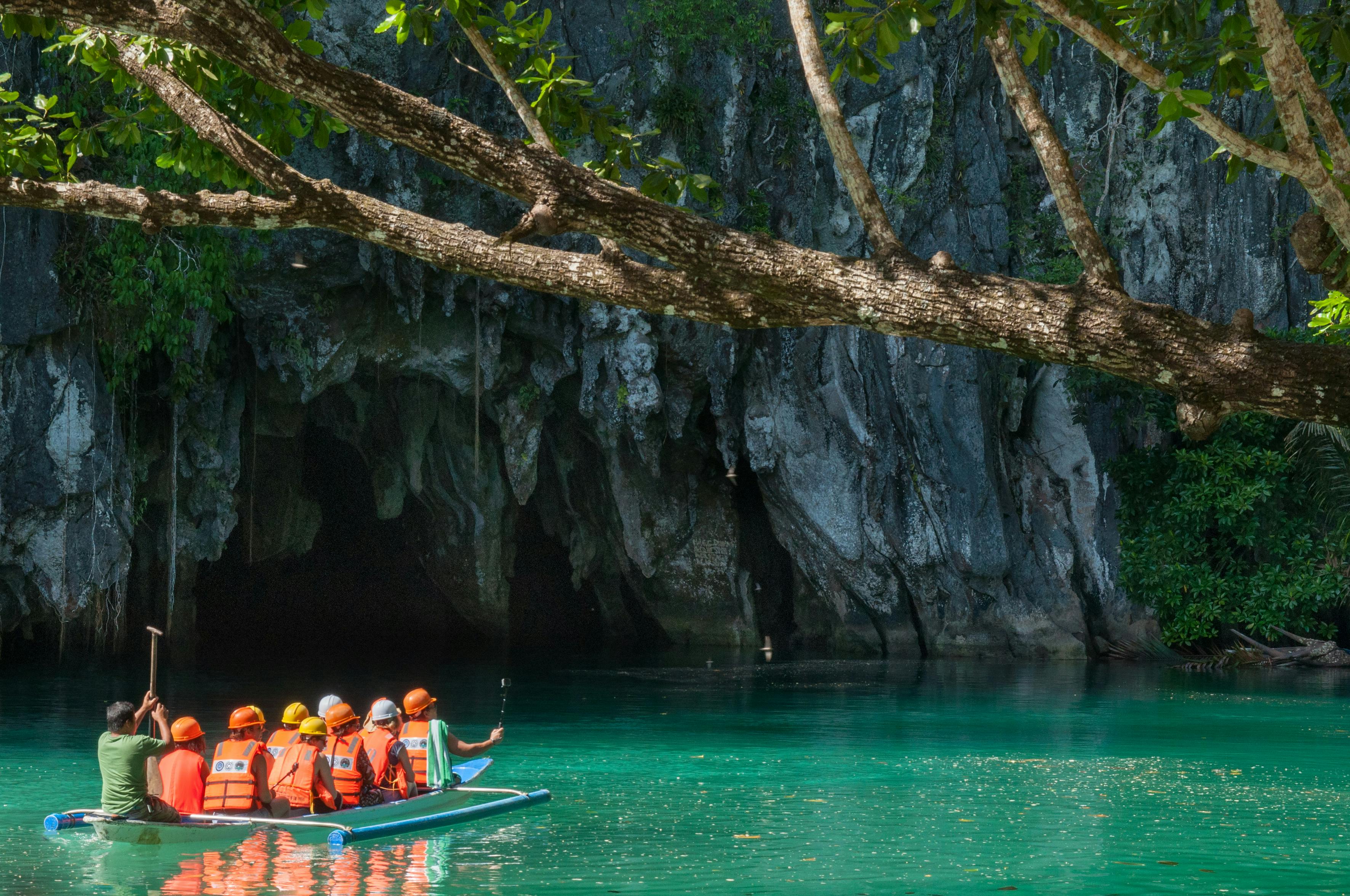 Tourists wearing life vests while going inside the Puerto Princesa Underground River in Palawan