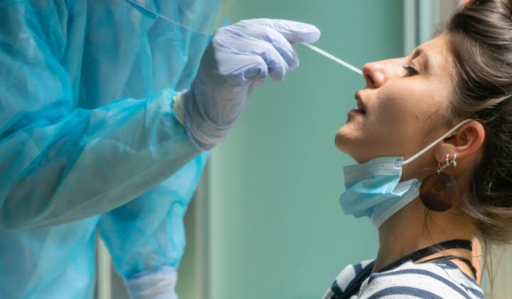 Woman receiving nasal swab required for antigen test