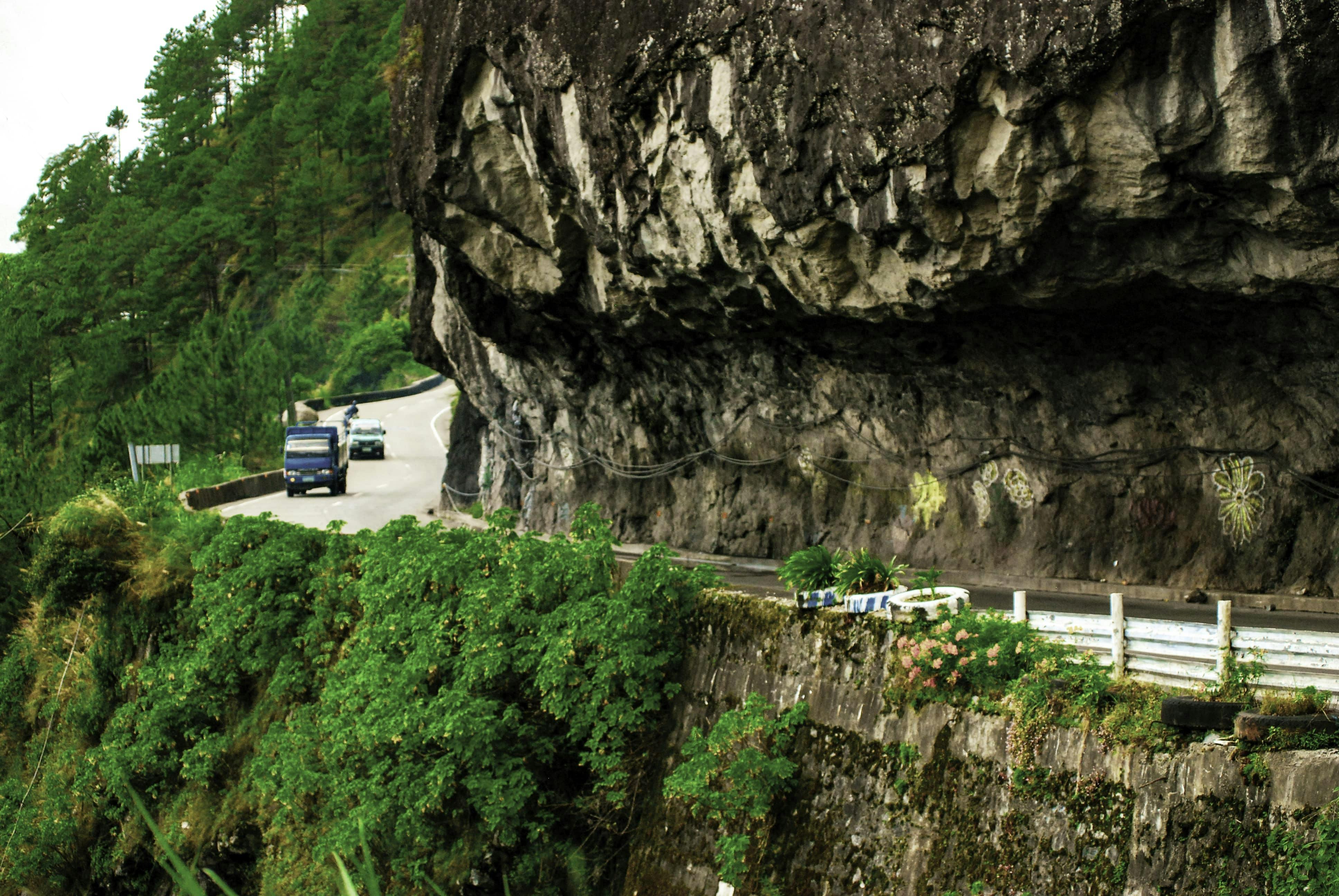A vehicle driving along the 2nd Highest Point, a popular tourist spot in Banaue