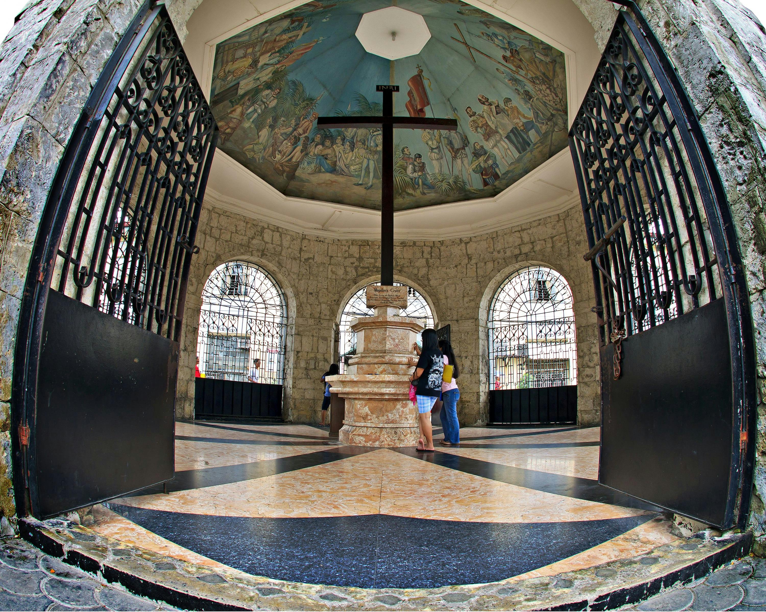 Residents and tourists alike visit the Magellan's Cross to say their prayers