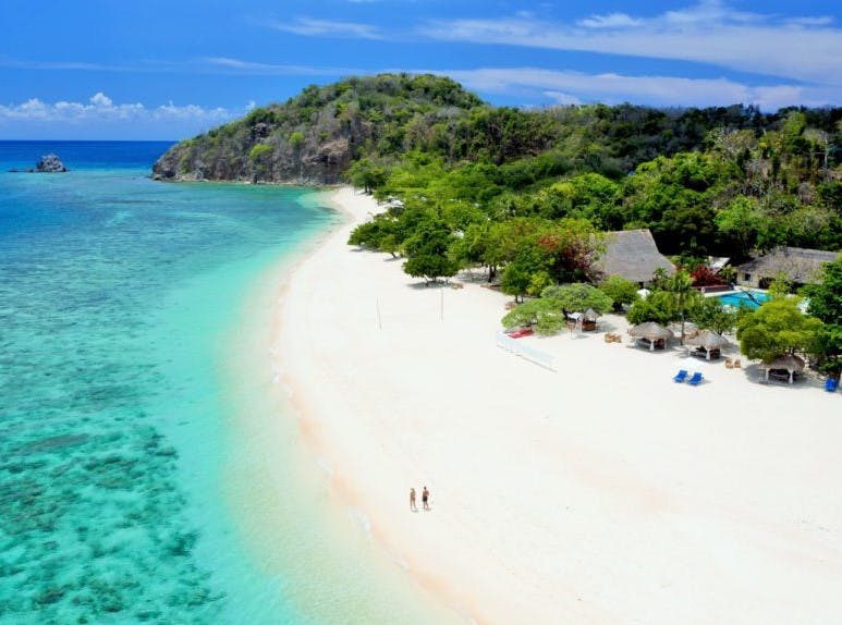 Long stretch of white sand beaches of Club Paradise Resort