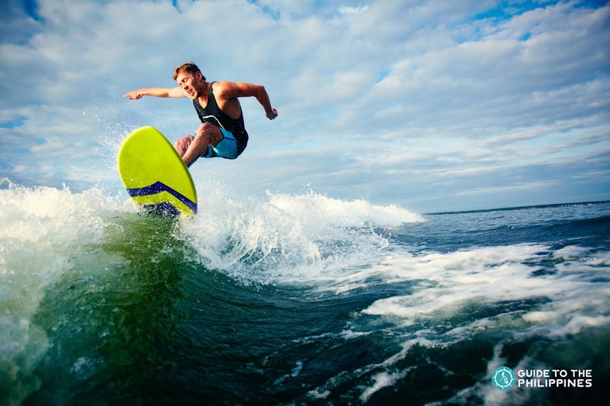 A surfer riding the waves of Siargao