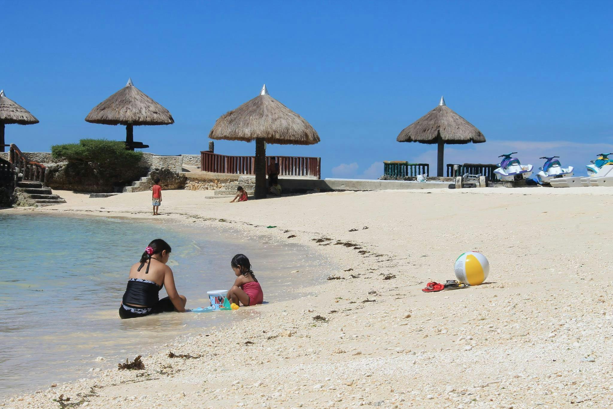 Kids playing with sand in front of a resort in Camotes Island