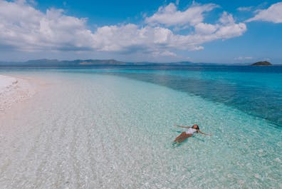 A woman enjoying the waters of Starfish Island in Palawan