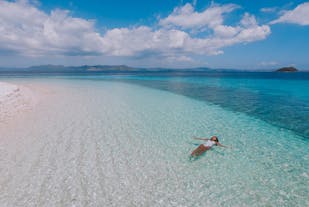 A woman floating on the beautiful beach of Starfish Island