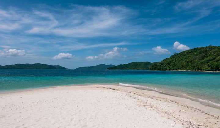 White sand beach and clear blue waters in Port Barton Palawan