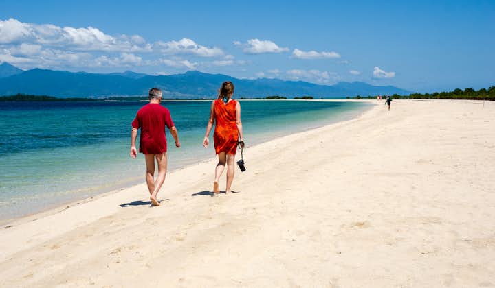 A couple enjoying the white sand beach of Honda Bay in Palawan