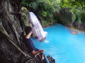 A man staring at the beauty of Kawasan Falls