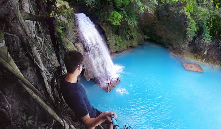 A man staring at the beauty of Kawasan Falls