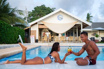 A couple enjoying their time at the pool of Cebu Seaview Dive Resort