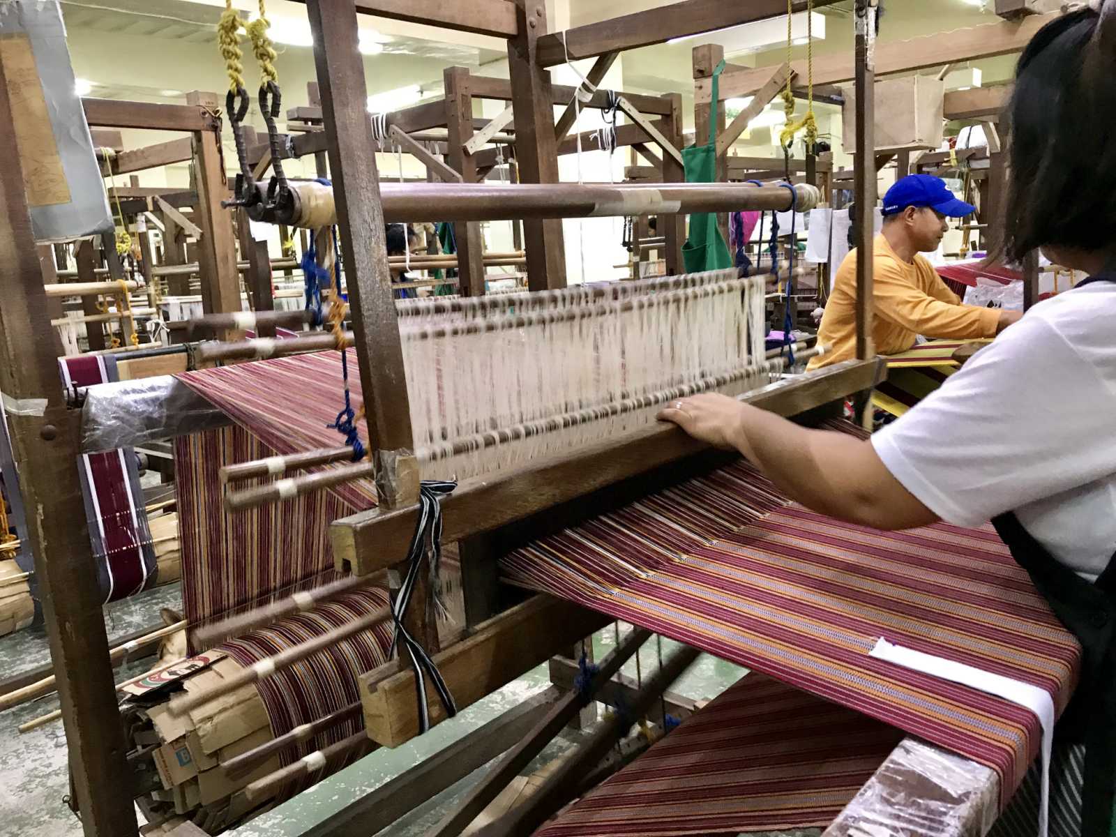 A woman weaving using a loom at Easter Weaving House in Baguio