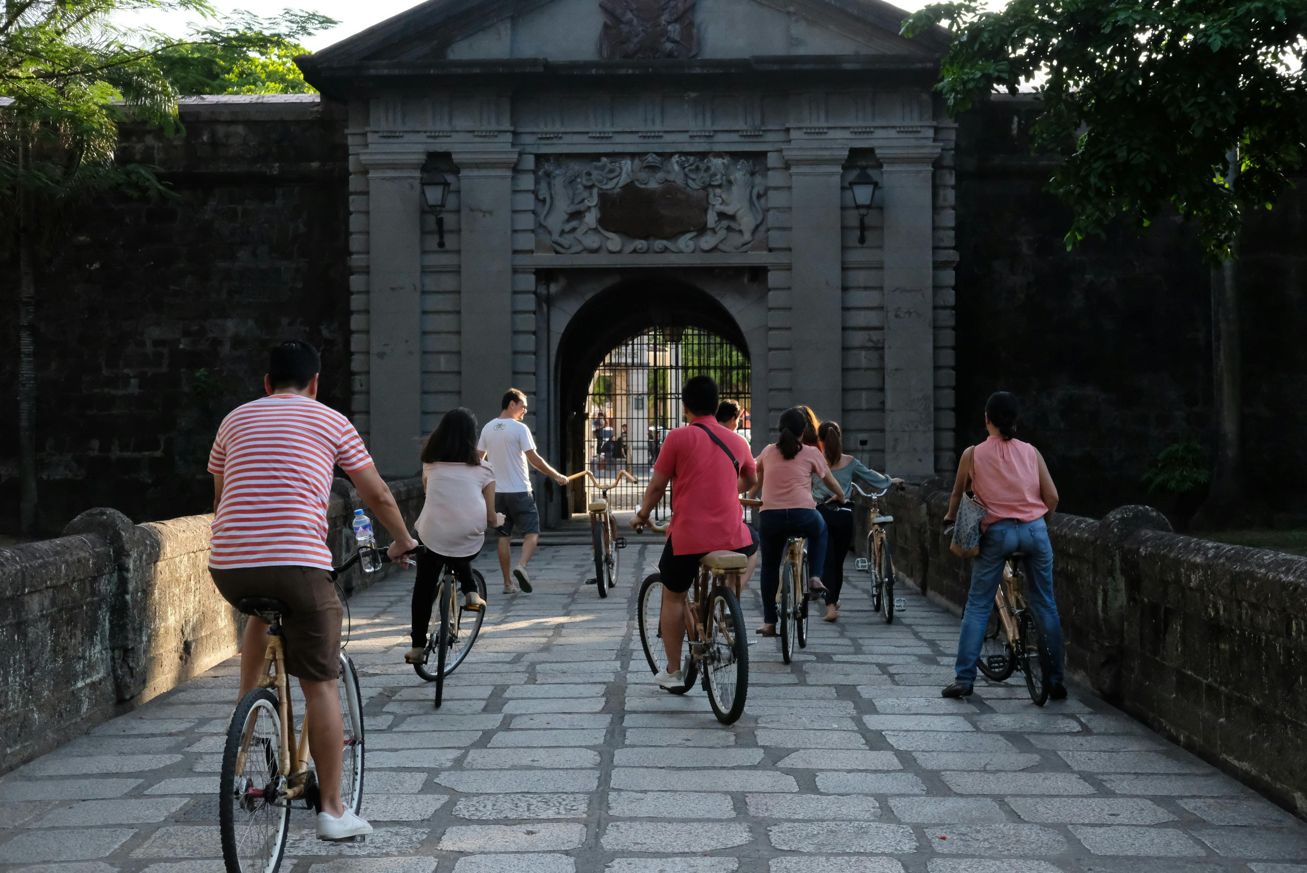 A group of people biking inside Intramuros