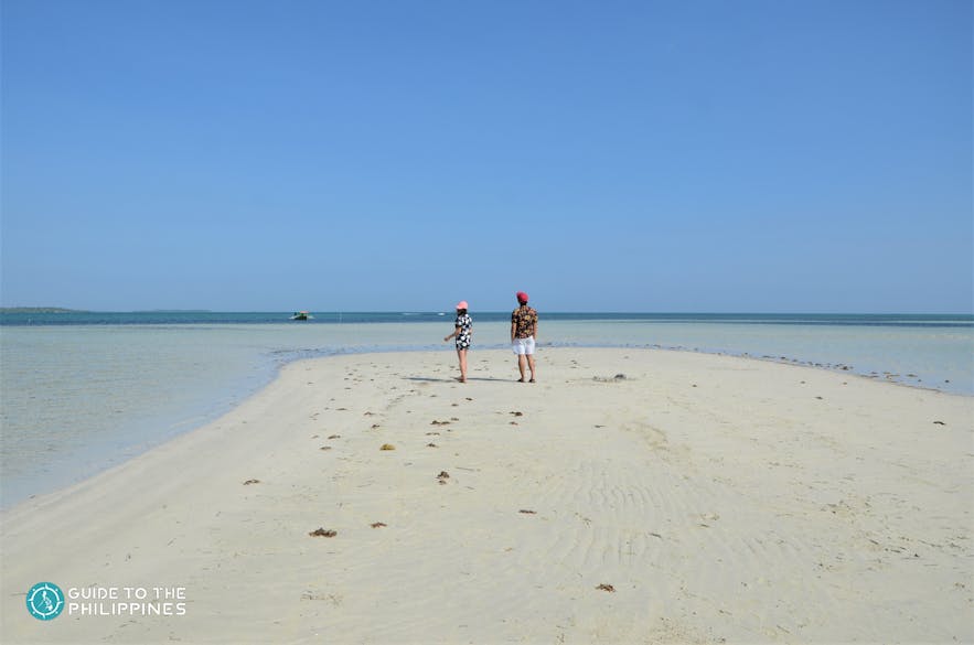 A couple stands on Tondol White Sand Beach in Pangasinan