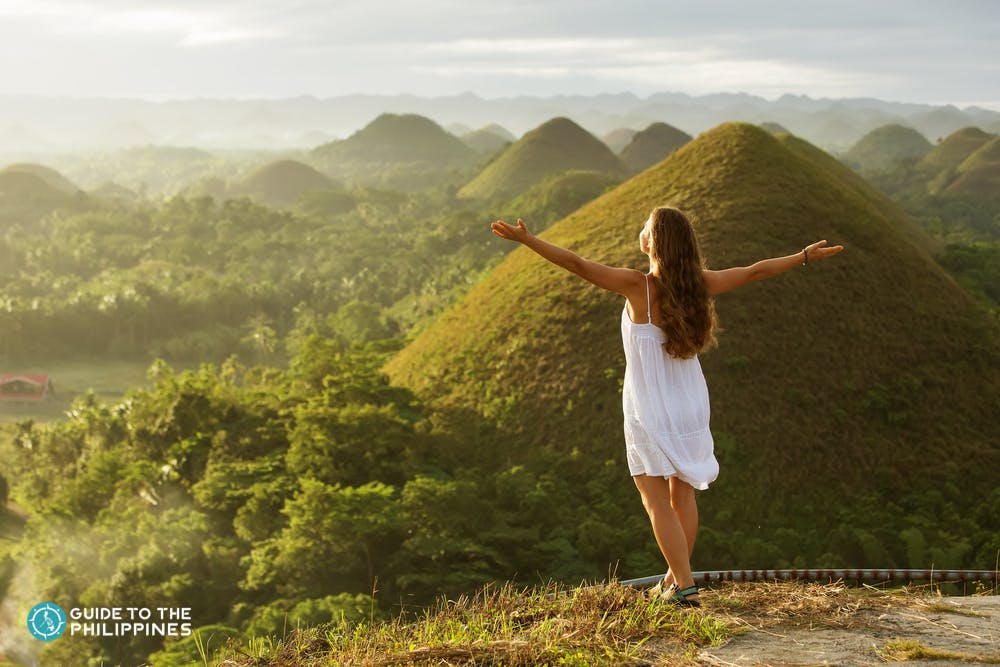 A woman enjoying the sunset at Chocolate hills in Bohol