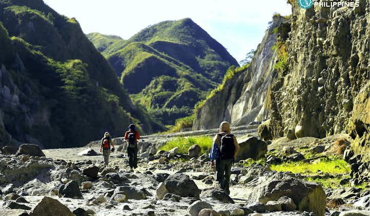 Trekking the rocky path going to the peak of Mt. Pinatubo