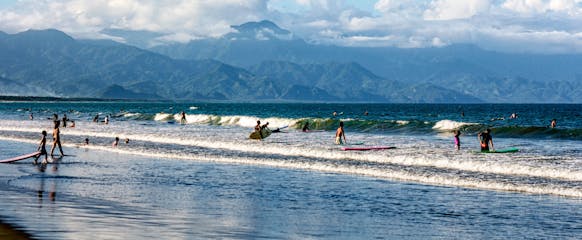 Tourists surfing in Sabang Beach, Baler.jpg