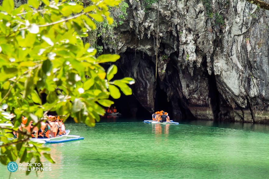 Tourists ride a boat to Puerto Princesa Underground River