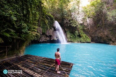 A man enjoying the view of Kawasan Falls in Cebu