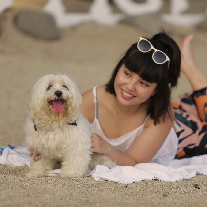 A woman and her dog on Sabangan Beach Resort's shore