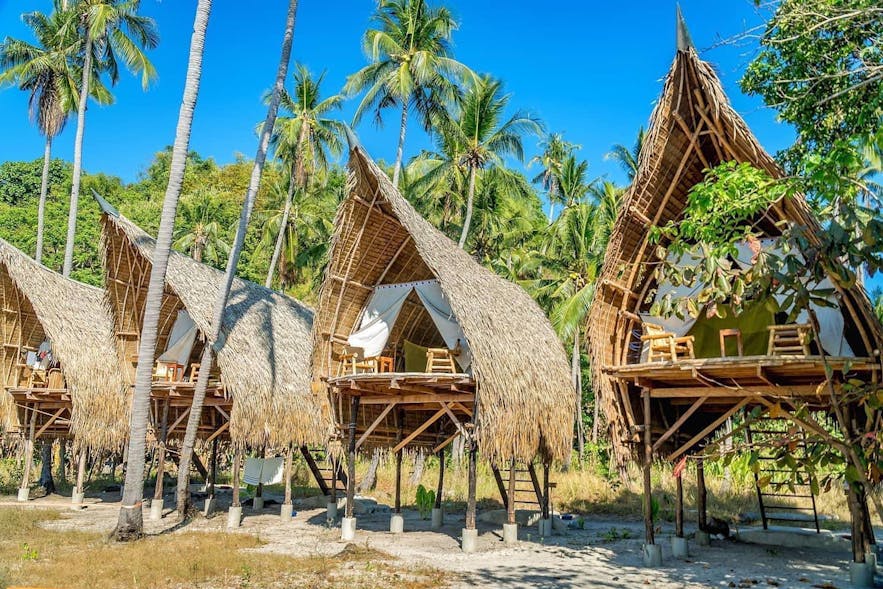 The beachside nipa huts of The Island Experience